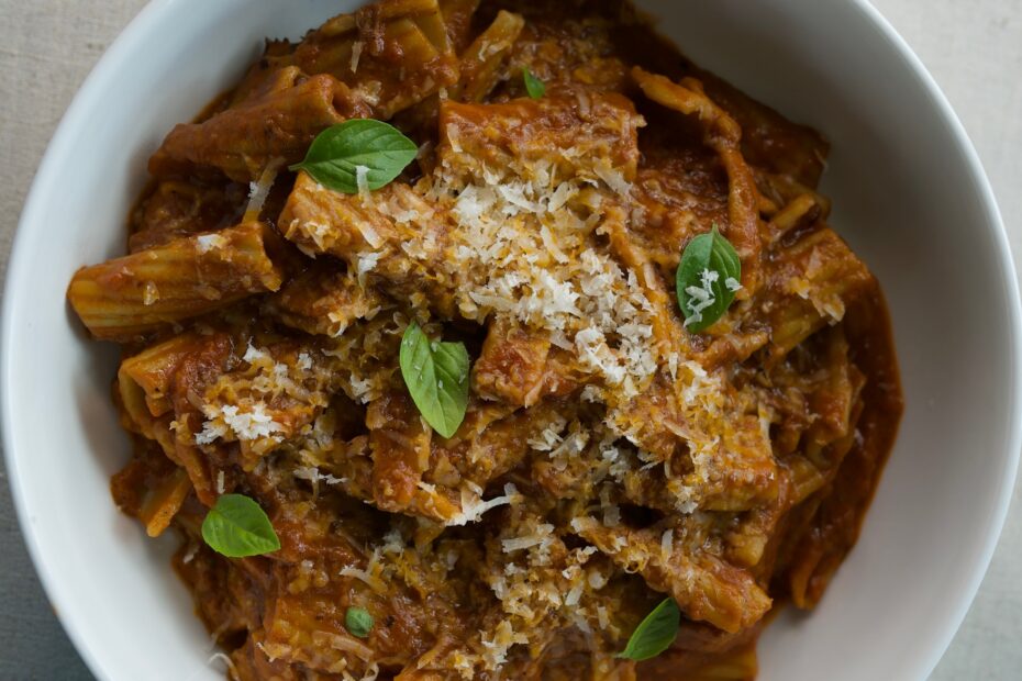 Braised short rib ragu tossed with rigatoni pasta, topped with fresh basil and grated Parmesan cheese