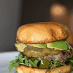 Homemade organic smash burger with crispy edges and melted cheese on a toasted bun