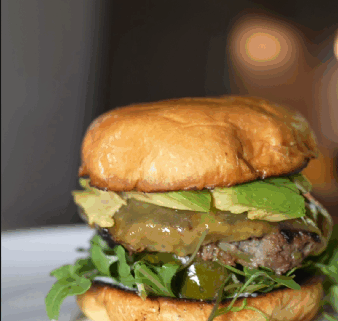 Homemade organic smash burger with crispy edges and melted cheese on a toasted bun