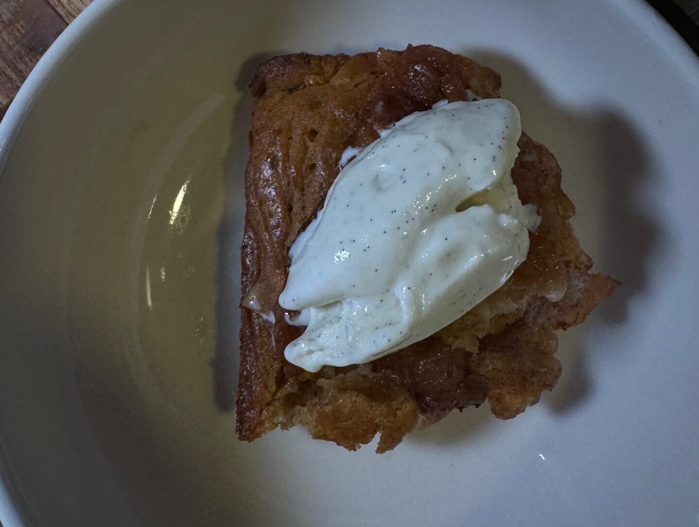 Homemade organic peach cobbler baked with fresh peaches and a golden, crisp topping, styled in a rustic dish for a high-vibrational recipe.