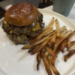 Juicy grass-fed mushroom swiss smash burger with melty Swiss cheese, sautéed shiitake and baby bella mushrooms, on toasted bun with garlic aioli