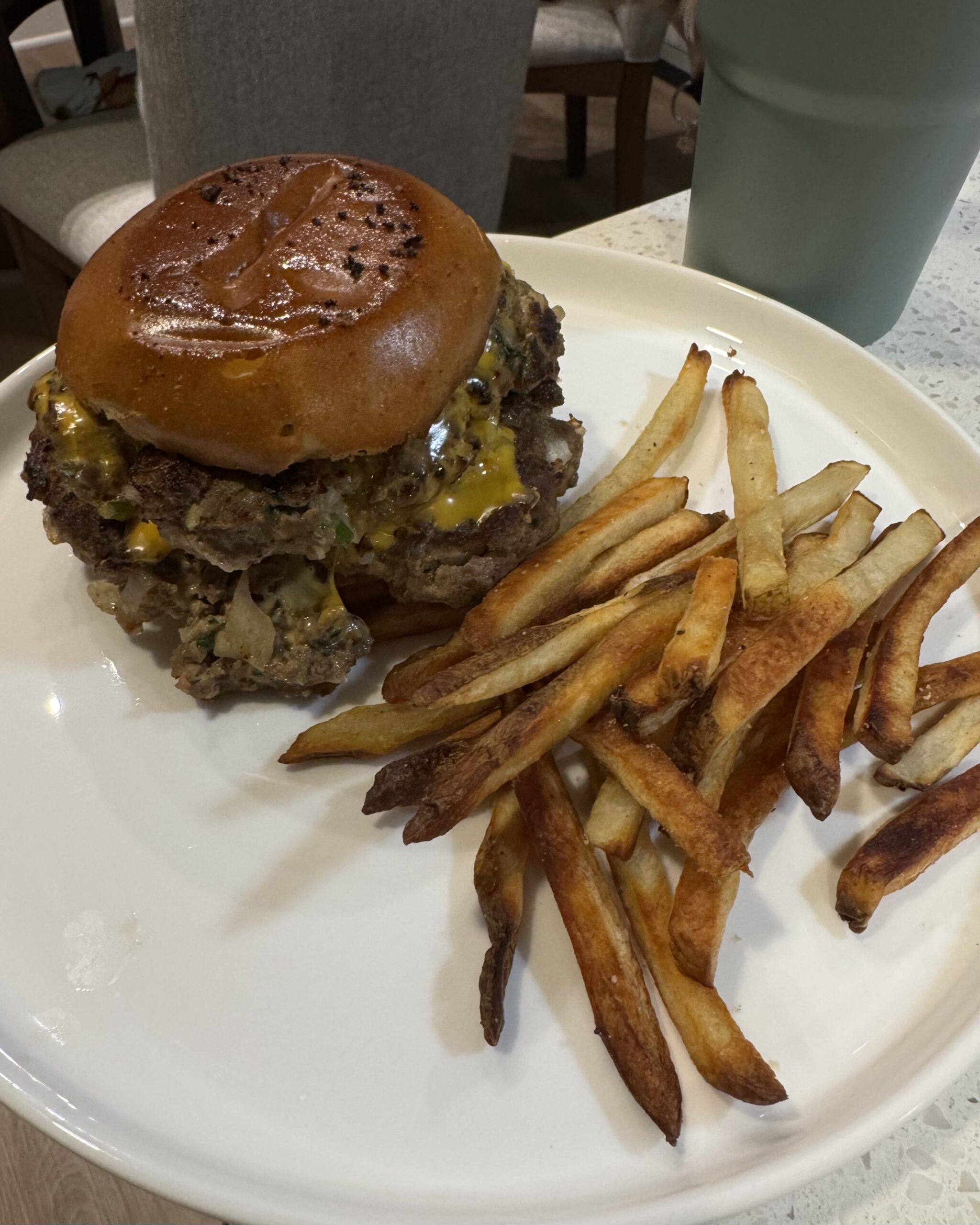 Juicy grass-fed mushroom swiss smash burger with melty Swiss cheese, sautéed shiitake and baby bella mushrooms, on toasted bun with garlic aioli